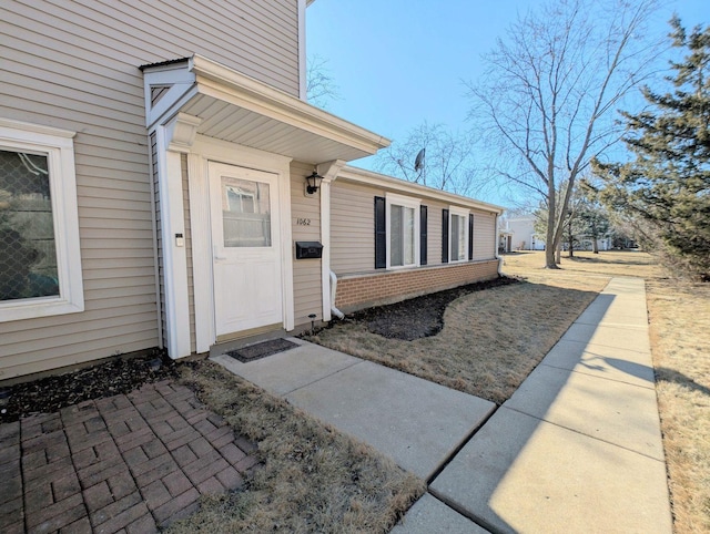 property entrance with brick siding