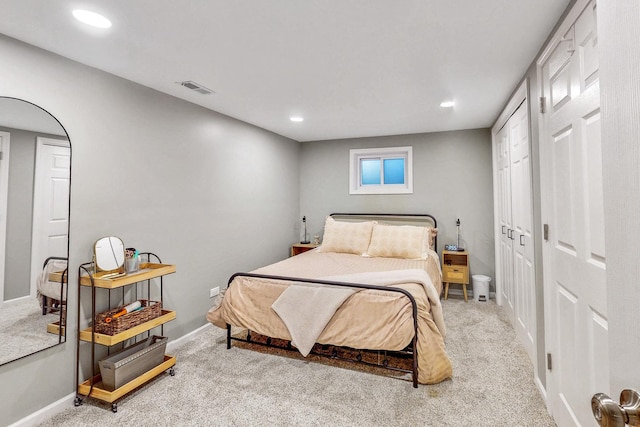 bedroom with recessed lighting, visible vents, light carpet, and baseboards