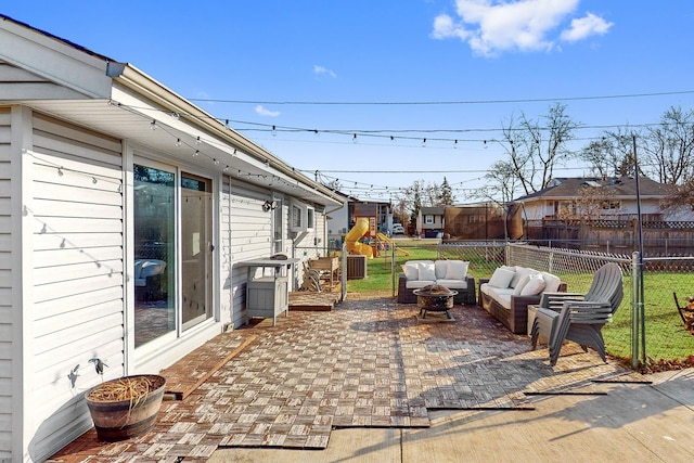 view of patio with an outdoor living space with a fire pit and fence