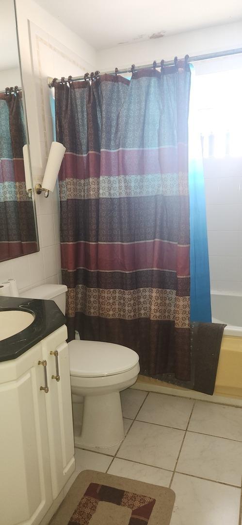 full bath featuring tile patterned floors, toilet, and vanity