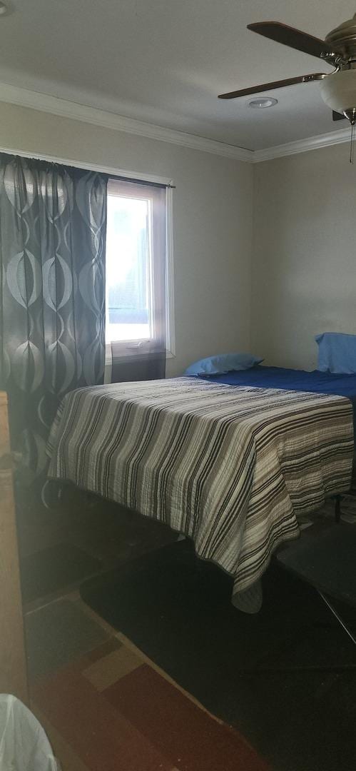 bedroom featuring ceiling fan and crown molding