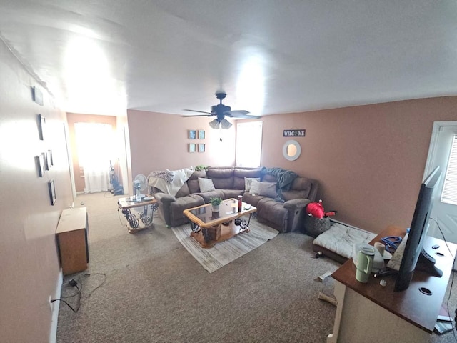 carpeted living area featuring ceiling fan