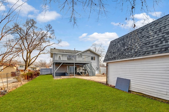 rear view of property with a shingled roof, a patio, a fenced backyard, stairs, and a deck