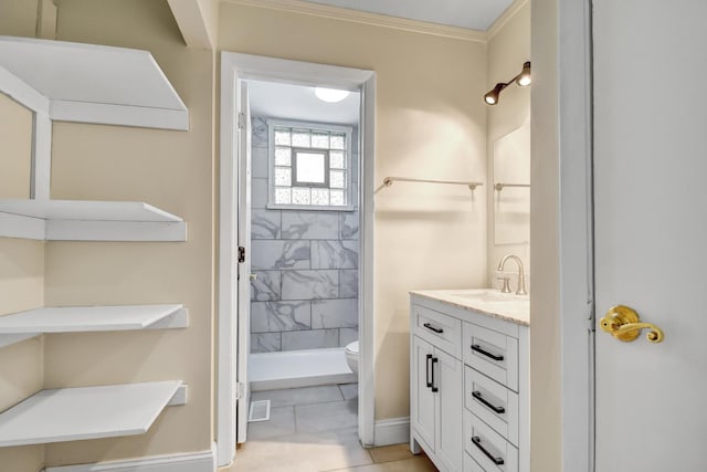 bathroom featuring toilet, vanity, baseboards, ornamental molding, and walk in shower