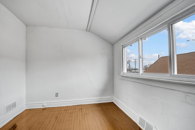 14719 Wood St, Harvey, IL 60426 - empty room featuring vaulted ceiling, wood-type flooring, visible vents, and baseboards