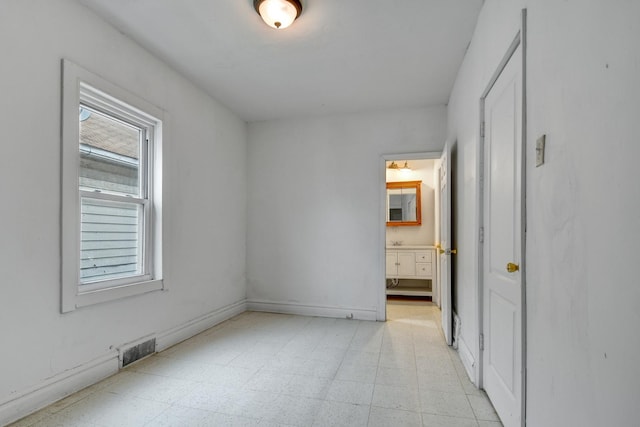 14719 Wood St, Harvey, IL 60426 - unfurnished bedroom with light floors, ensuite bath, and visible vents