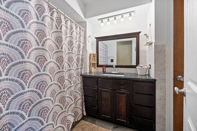 bathroom with tile walls and vanity