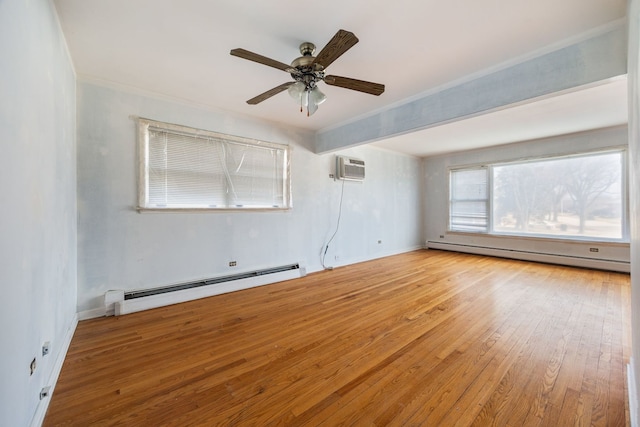 spare room with ornamental molding, a baseboard radiator, ceiling fan, and hardwood / wood-style floors