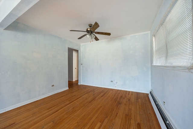 unfurnished room with a baseboard heating unit, baseboards, hardwood / wood-style flooring, and a ceiling fan