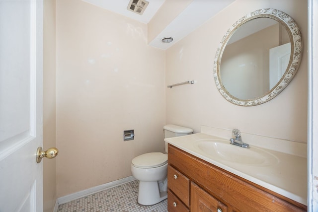 half bathroom with toilet, vanity, visible vents, baseboards, and tile patterned floors