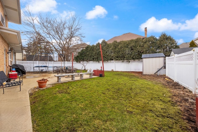 view of yard featuring an outbuilding, a fenced backyard, a patio, and a shed