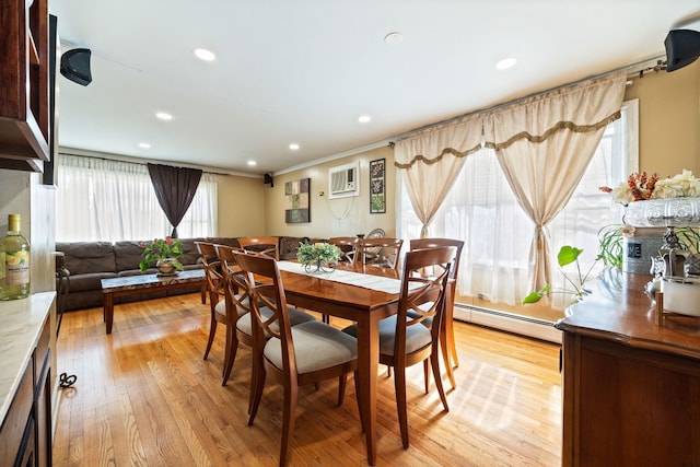 dining space with light wood-type flooring, baseboard heating, an AC wall unit, and recessed lighting