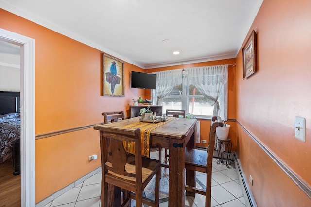 dining area featuring baseboards, baseboard heating, and light tile patterned flooring