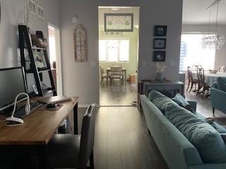 living room featuring a notable chandelier and wood finished floors