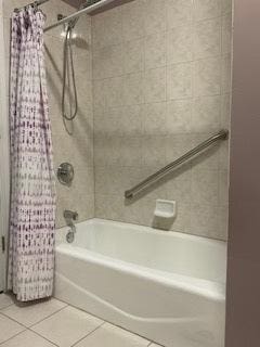 full bath with shower / bathtub combination with curtain and tile patterned floors