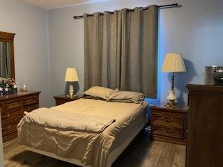 bedroom featuring wood finished floors