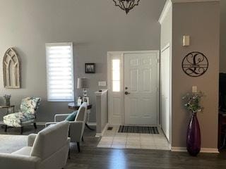 entrance foyer with baseboards and wood finished floors