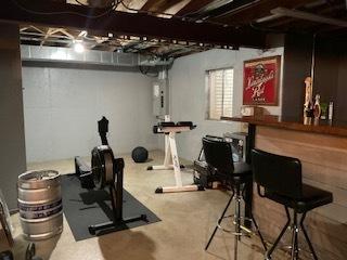 exercise room with a bar and electric panel