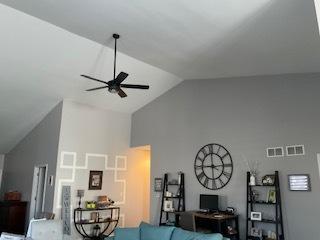 living room featuring ceiling fan and high vaulted ceiling