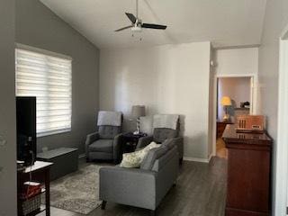 living room featuring vaulted ceiling, ceiling fan, and wood finished floors