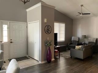 living area featuring vaulted ceiling, wood finished floors, and baseboards