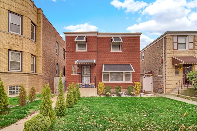 view of front facade featuring brick siding and a front lawn