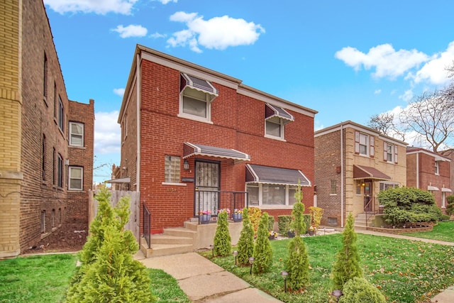 view of front of property featuring brick siding and a front lawn