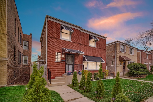 view of front of property with brick siding and a front lawn