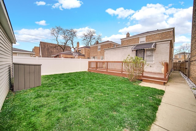 view of yard with a fenced backyard and a deck