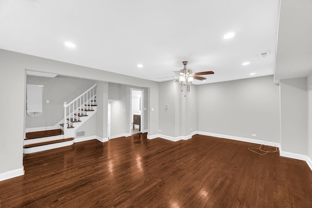 unfurnished living room with baseboards, stairs, visible vents, and wood finished floors