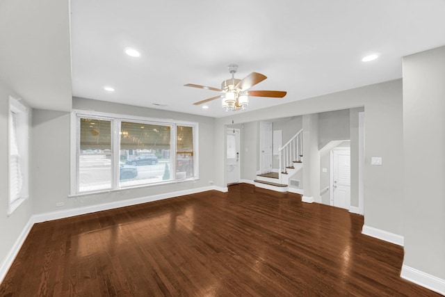 unfurnished living room featuring baseboards, a ceiling fan, wood finished floors, stairs, and recessed lighting