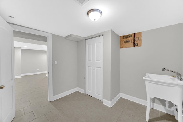 bathroom featuring visible vents, a sink, and baseboards