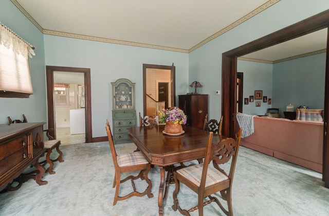 dining space featuring carpet and crown molding