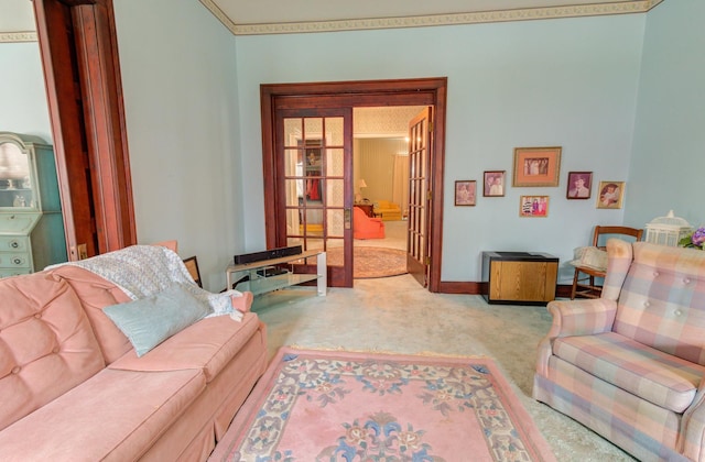 carpeted living area with baseboards and french doors