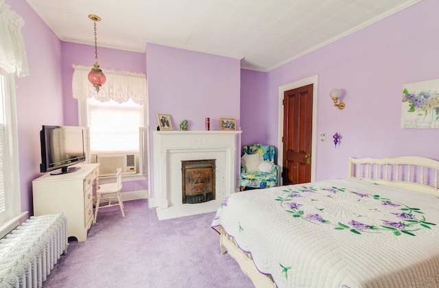 bedroom with a fireplace with flush hearth, crown molding, and carpet flooring