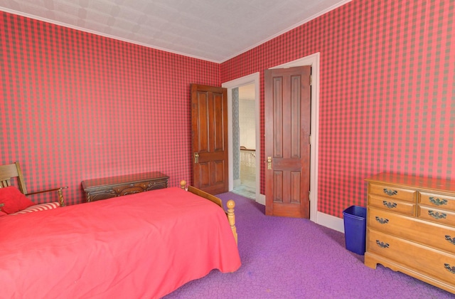 bedroom featuring carpet flooring, crown molding, baseboards, and wallpapered walls