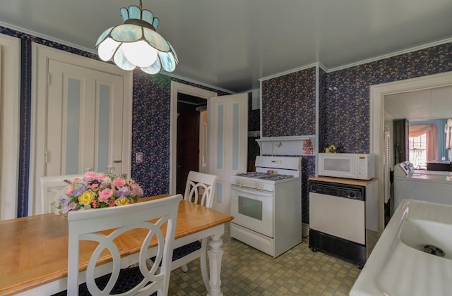 kitchen featuring white appliances and wallpapered walls