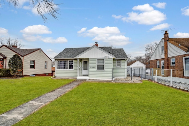 bungalow with roof with shingles, a detached garage, board and batten siding, fence, and a front lawn