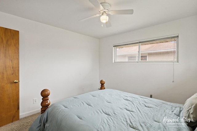 carpeted bedroom with a ceiling fan and baseboards