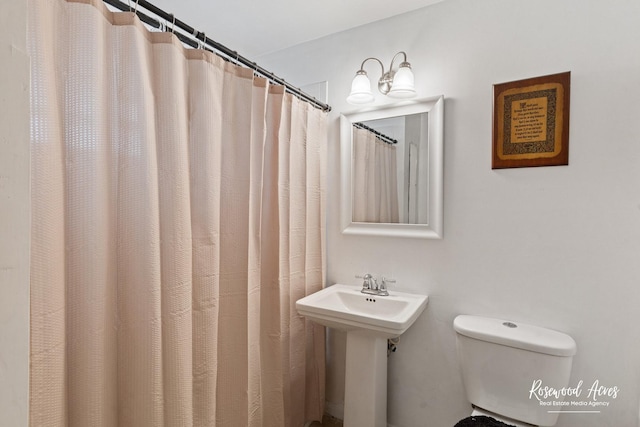 full bathroom with toilet and a sink