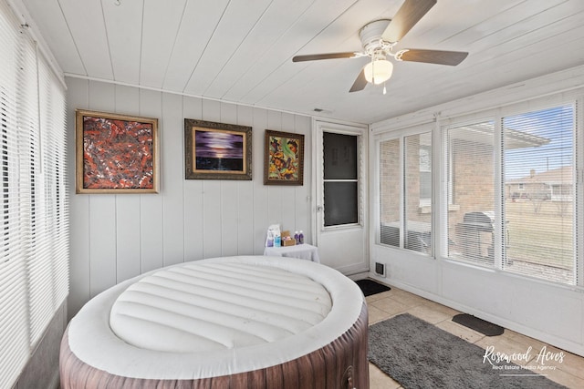 bedroom featuring wood ceiling, multiple windows, a ceiling fan, and light tile patterned flooring