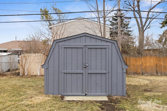 view of shed featuring fence