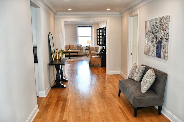 hallway with ornamental molding, light wood-type flooring, recessed lighting, and baseboards