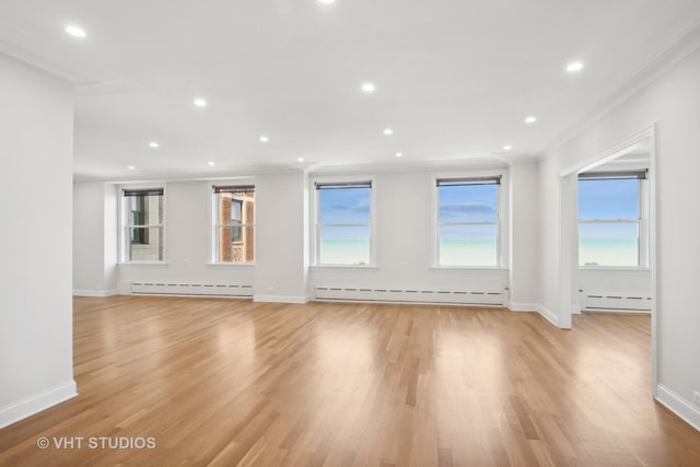 unfurnished living room featuring ornamental molding, a baseboard radiator, recessed lighting, and light wood-style floors