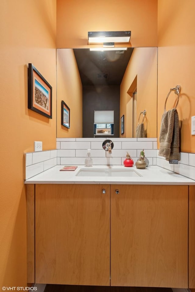 bathroom featuring decorative backsplash and vanity