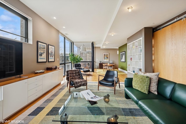 living room with recessed lighting, expansive windows, baseboards, and wood finished floors