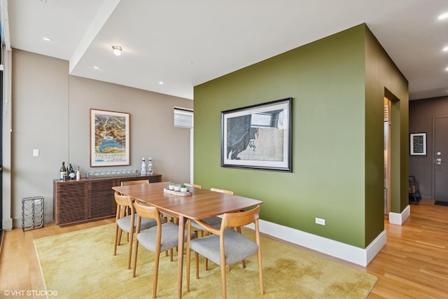 dining space featuring recessed lighting, baseboards, and light wood finished floors