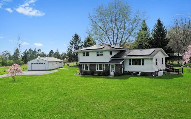 view of front of house featuring an outdoor structure, a garage, a front yard, and central AC unit
