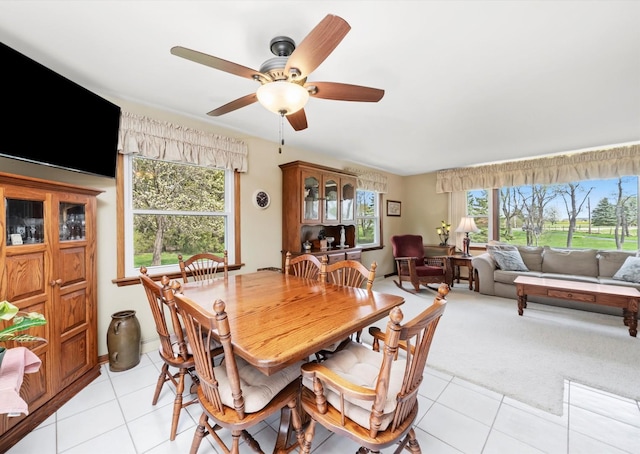 dining space with light tile patterned floors, ceiling fan, and a healthy amount of sunlight