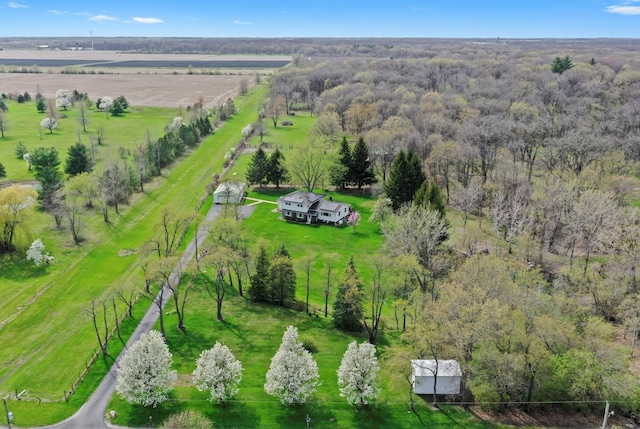 bird's eye view with a rural view and a wooded view